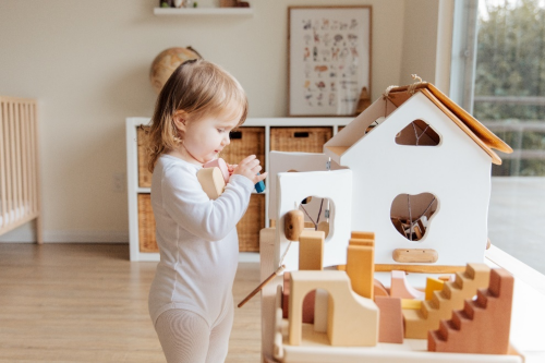 Toddler holding wooden blocks